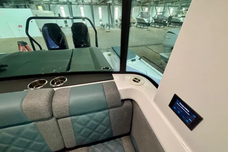 Slide: The Image of 2024 Axopar 37 XC Cross Cabin interior with stylish seating and cup holders. - 71