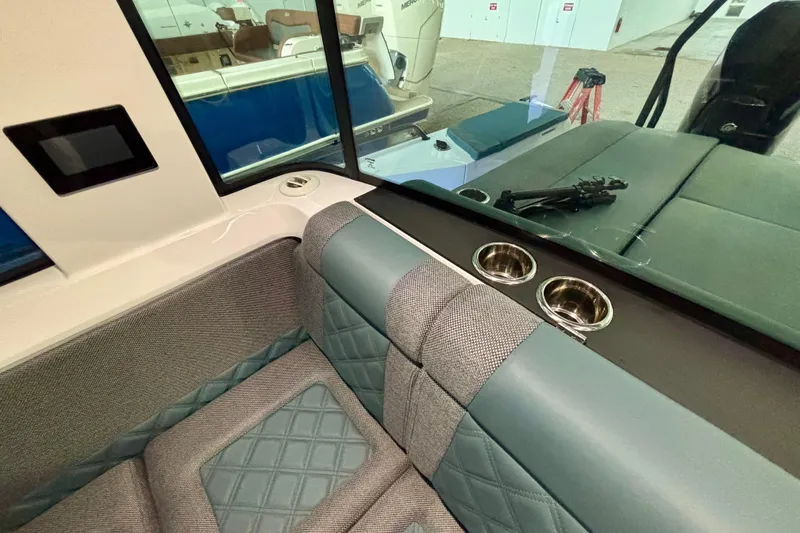 Slide: The Image of 2024 Axopar 37 XC Cross Cabin interior with cozy gray bedding and cushions. - 72