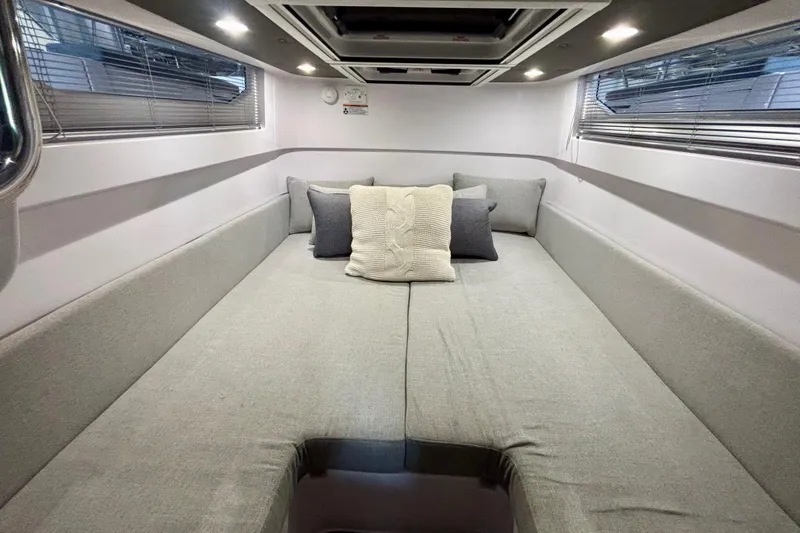 Slide: The Image of 2024 Axopar 37 XC Cross Cabin interior with control panel and seating. - 73