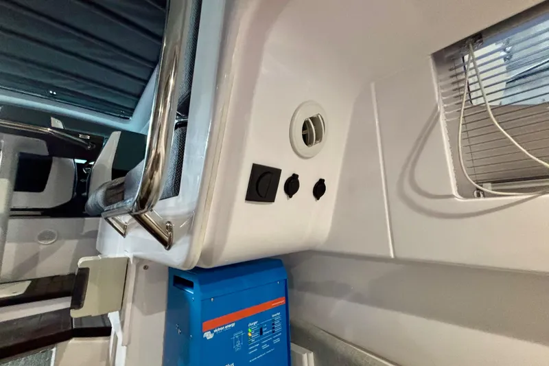 Slide: The Image of 2024 Axopar 37 XC Cross Cabin interior with modern seating and window blinds. - 74