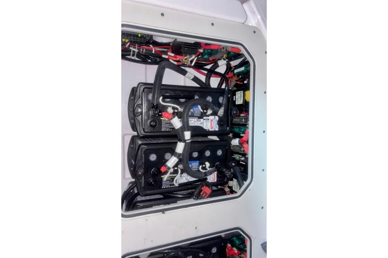 Slide: The Image of Battery compartment of 2024 Axopar 37 XC Cross Cabin with wiring and connections. - 78