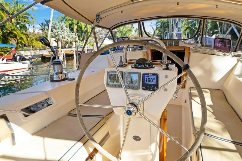 Slide: The Image of Cockpit of 2006 Island Packet 440 sailboat with steering wheel and navigation instruments. - 11