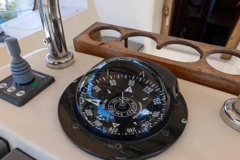 Slide: The Image of Compass and controls on a 2006 Island Packet 440 sailboat. - 12