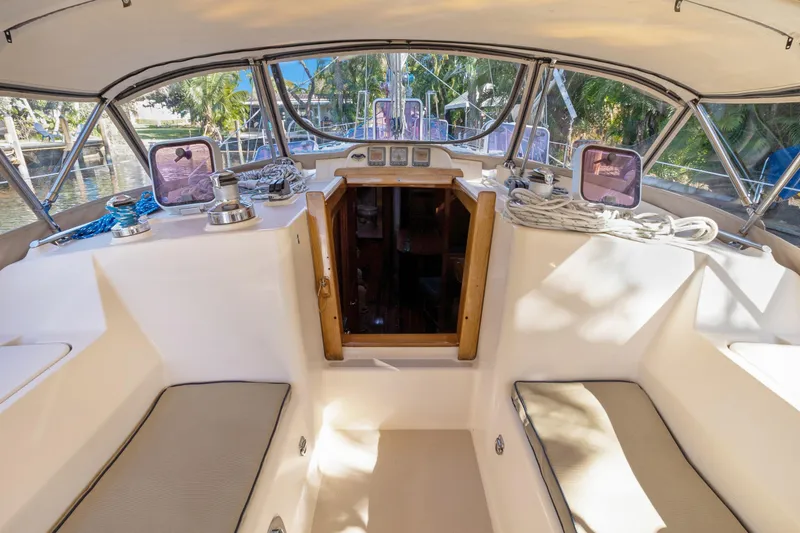 Slide: The Image of Cockpit of 2006 Island Packet 440 sailboat with seating and navigation equipment. - 13