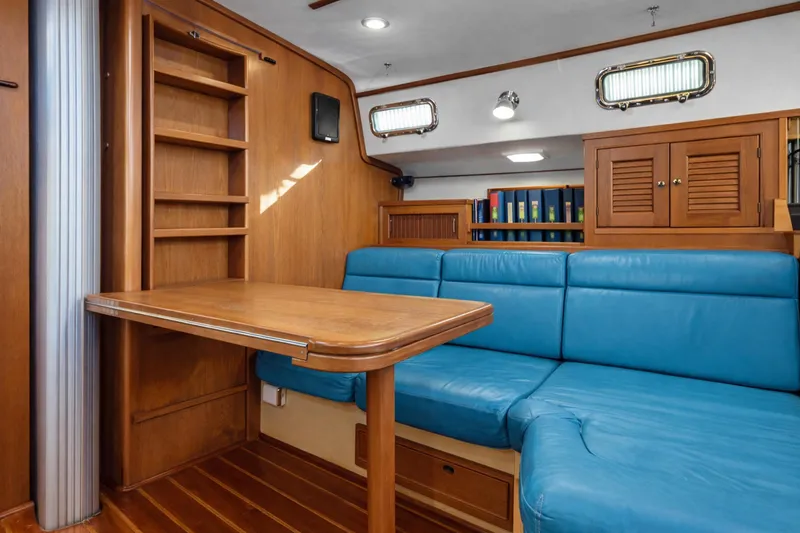 Slide: The Image of Interior of 2006 Island Packet 440 yacht with blue seating and wooden table. - 18