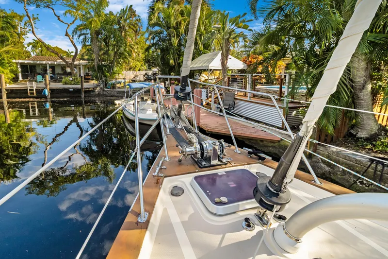 Slide: The Image of Sailboat docked in tropical setting, Island Packet 440, 2006 model, surrounded by lush greenery. - 2