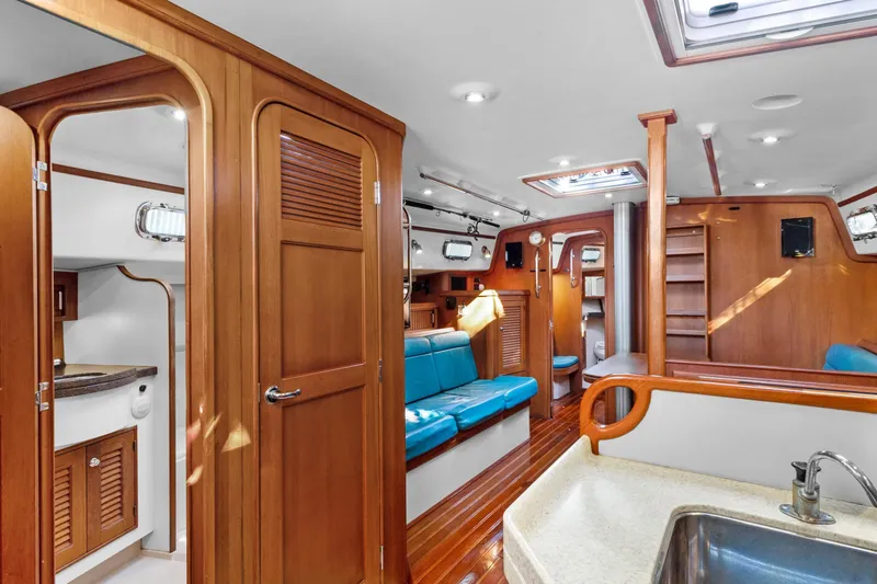 Slide: The Image of Interior of 2006 Island Packet 440 yacht with wood finish and blue seating. - 20