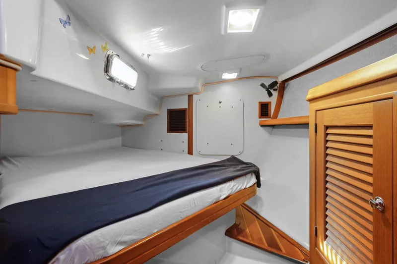 Slide: The Image of Cozy cabin interior of 2006 Island Packet 440 sailboat with wooden accents and butterfly decor. - 26