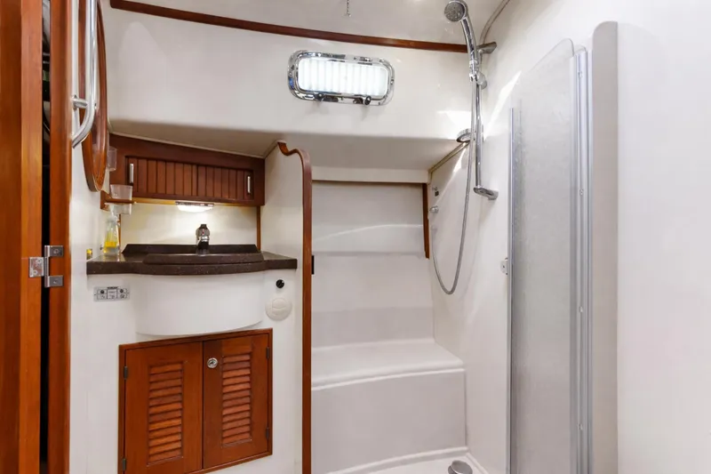 Slide: The Image of Luxurious bathroom interior of 2006 Island Packet 440 yacht with shower and wooden cabinetry. - 29