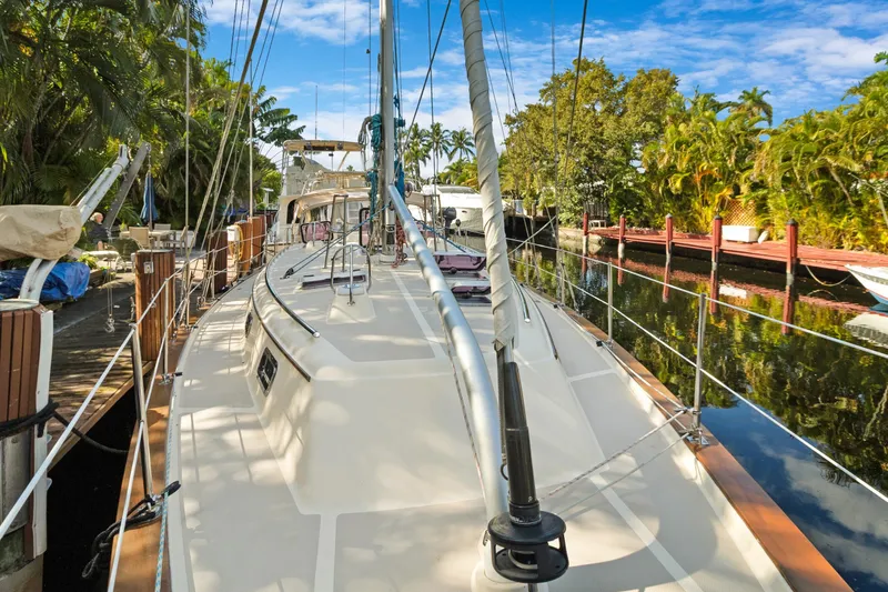 Slide: The Image of 2006 Island Packet 440 sailboat docked in a lush, tropical marina setting. - 3