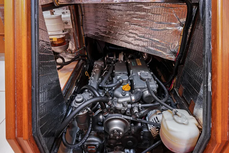 Slide: The Image of Engine compartment of a 2006 Island Packet 440 sailboat, showcasing detailed mechanical components. - 31