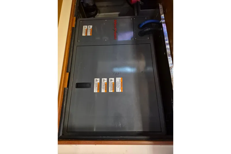 Slide: The Image of Electrical panel on 2006 Island Packet 440 sailboat, featuring safety warning labels. - 33