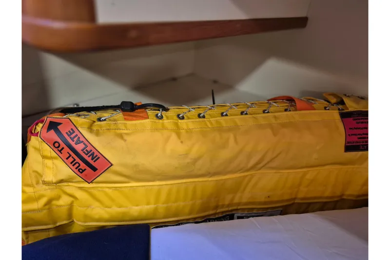 Slide: The Image of Yellow life raft with "Pull to Inflate" tag on 2006 Island Packet 440 yacht. - 36