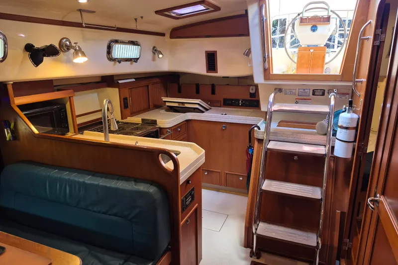 Slide: The Image of Interior of 2006 Island Packet 440 sailboat with kitchen and seating area. - 38