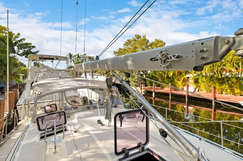 Slide: The Image of 2006 Island Packet 440 sailboat docked, showcasing deck and rigging under a clear sky. - 5