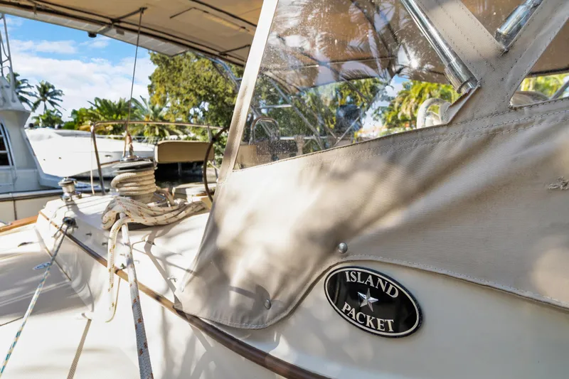 Slide: The Image of 2006 Island Packet 440 sailboat deck with ropes and canopy in marina setting. - 7