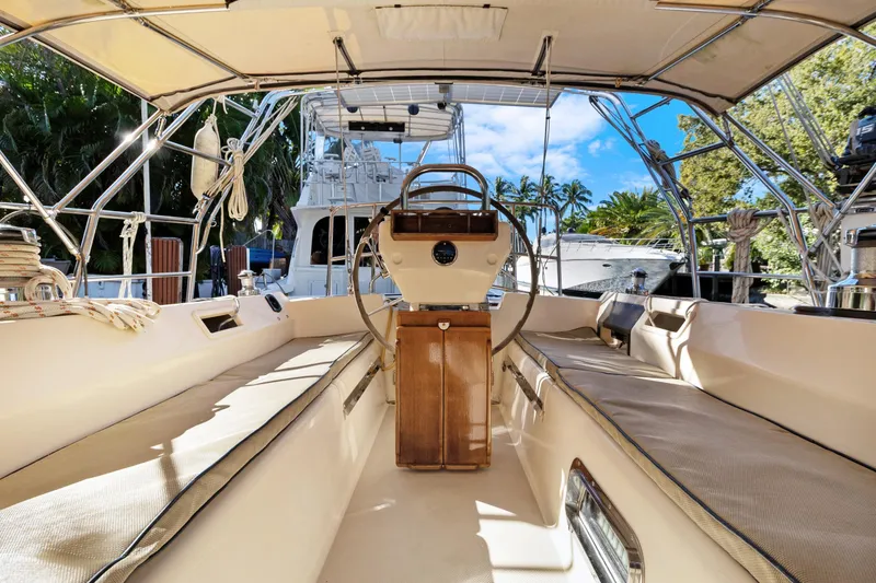 Slide: The Image of Interior view of 2006 Island Packet 440 sailboat cockpit with steering wheel and seating. - 9