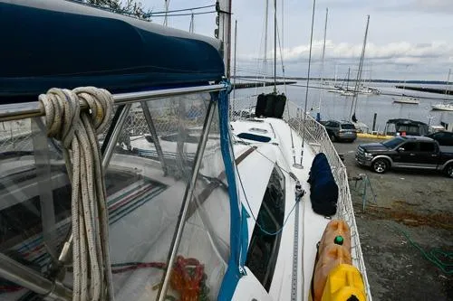 Slide: The Image of 2008 Beneteau Oceanis 46 sailboat with blue canopy docked at marina. - 18
