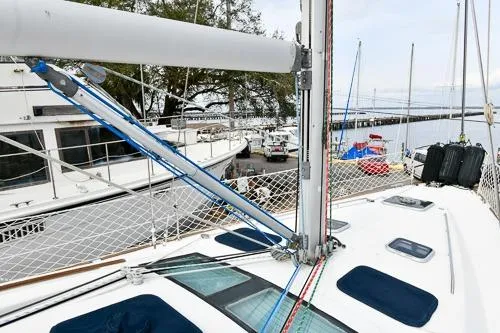Slide: The Image of 2008 Beneteau Oceanis 46 sailboat docked, with marina and vehicles in the background. - 19