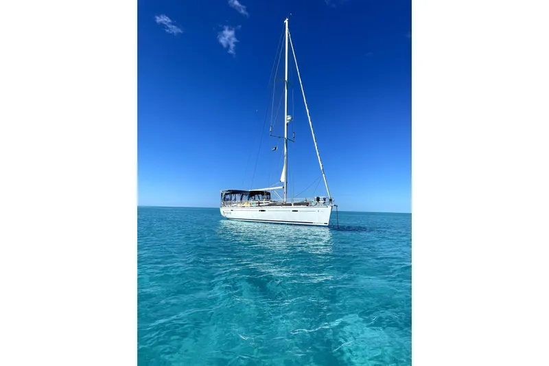 Slide: The Image of Beneteau Oceanis 46 sailboat from 2008 on clear blue ocean waters. - 2