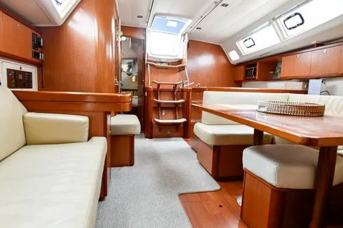 Slide: The Image of Luxurious interior of 2008 Beneteau Oceanis 46 yacht with wood finish and seating area. - 32