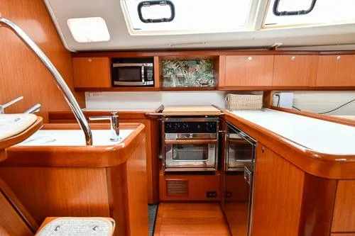 Slide: The Image of Interior of 2008 Beneteau Oceanis 46 yacht with modern seating and wooden finishes. - 33