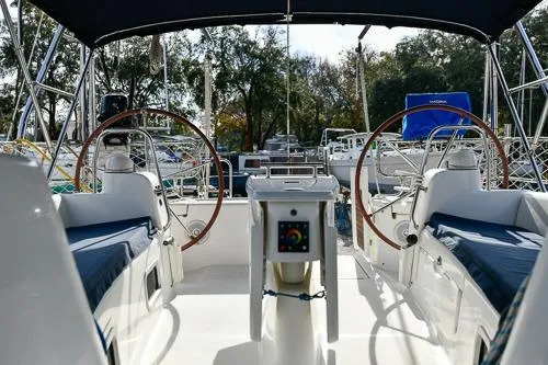 Slide: The Image of 2008 Beneteau Oceanis 46 sailboat cockpit with dual steering wheels and blue seating. - 4