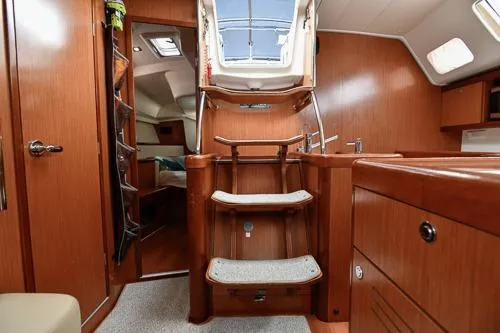 Slide: The Image of Interior cabin of 2008 Beneteau Oceanis 46 yacht with cozy bedding and wooden furnishings. - 43