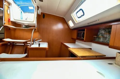Slide: The Image of Beneteau Oceanis 46 (2008) cabin interior with cozy bed and nautical decor. - 44
