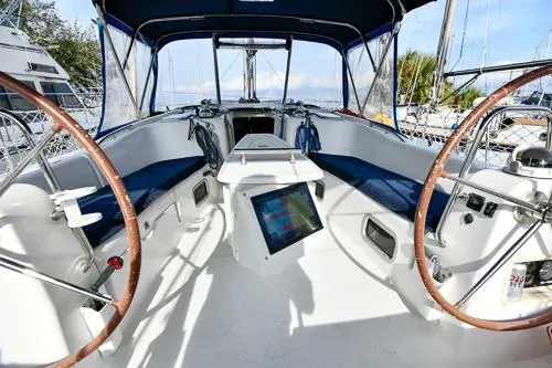 Slide: The Image of 2008 Beneteau Oceanis 46 sailboat cockpit with dual steering wheels and navigation equipment. - 5