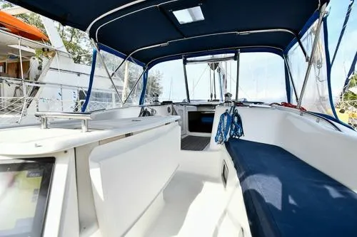Slide: The Image of 2008 Beneteau Oceanis 46 sailboat cockpit with blue canopy and seating. - 6