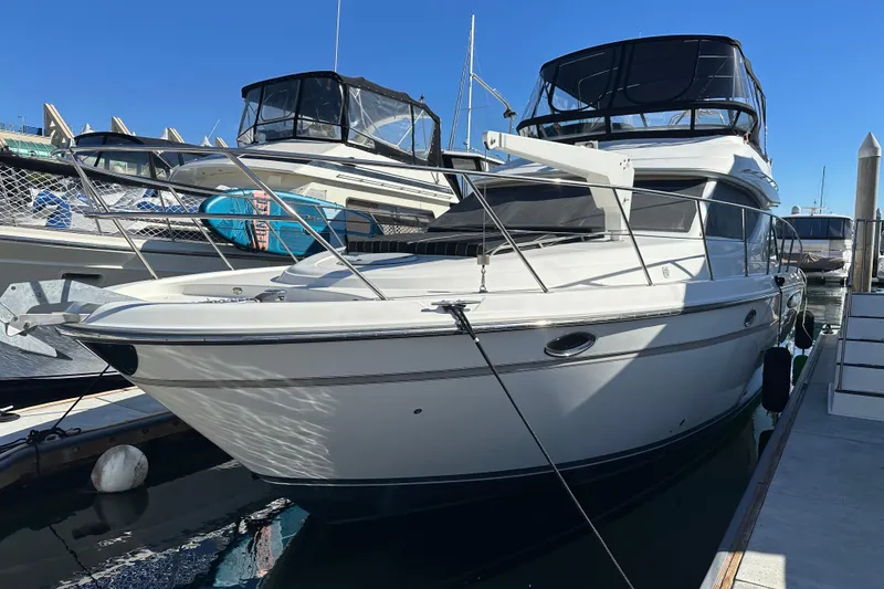 Slide: The Image of 2000 Maxum 4600 SCB yacht docked at marina under clear blue sky. - 1