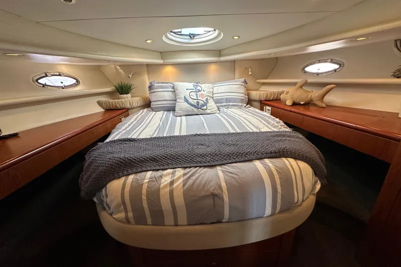 Slide: The Image of Luxurious bedroom interior of 2000 Maxum 4600 SCB yacht with striped bedding. - 16