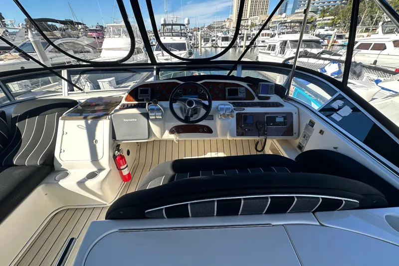 Slide: The Image of Helm of 2000 Maxum 4600 SCB yacht with modern navigation equipment and marina view. - 25