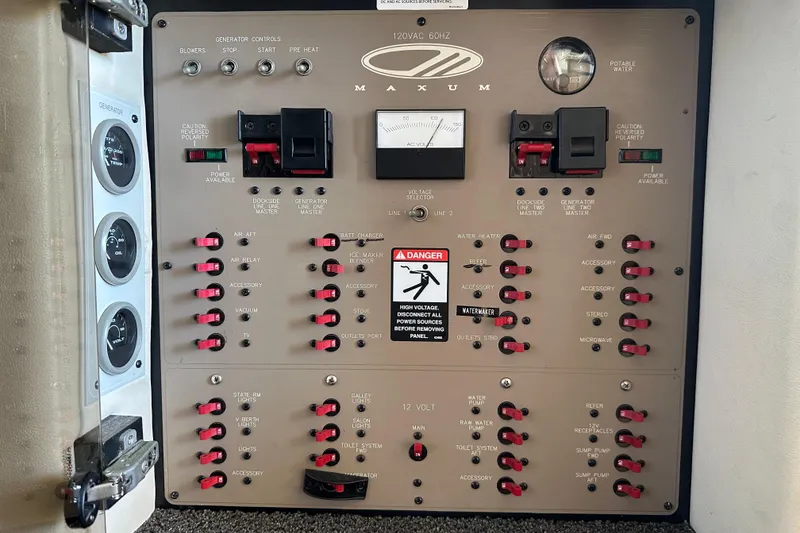Slide: The Image of Electrical control panel of a 2000 Maxum 4600 SCB boat, featuring various switches and gauges. - 41