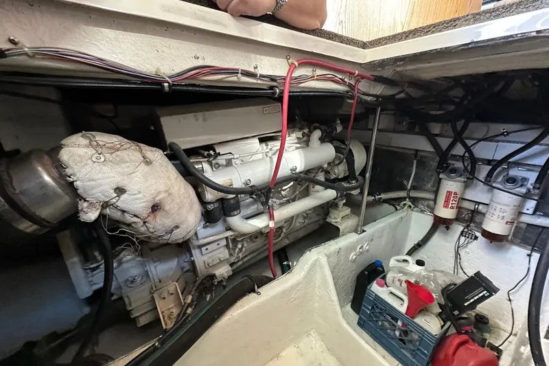 Slide: The Image of Engine room of a 2000 Maxum 4600 SCB yacht, showcasing mechanical components and wiring. - 45