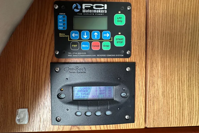 Slide: The Image of Control panels on a 2000 Maxum 4600 SCB boat, featuring FCI Watermakers and OutBack Power Systems. - 49