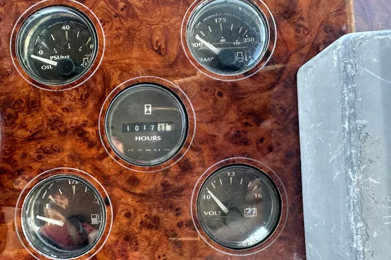 Slide: The Image of Dashboard gauges of a 2000 Maxum 4600 SCB boat, showing oil, temperature, fuel, and voltage. - 55