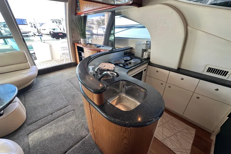 Slide: The Image of Luxurious kitchen interior of 2000 Maxum 4600 SCB yacht with modern amenities. - 9