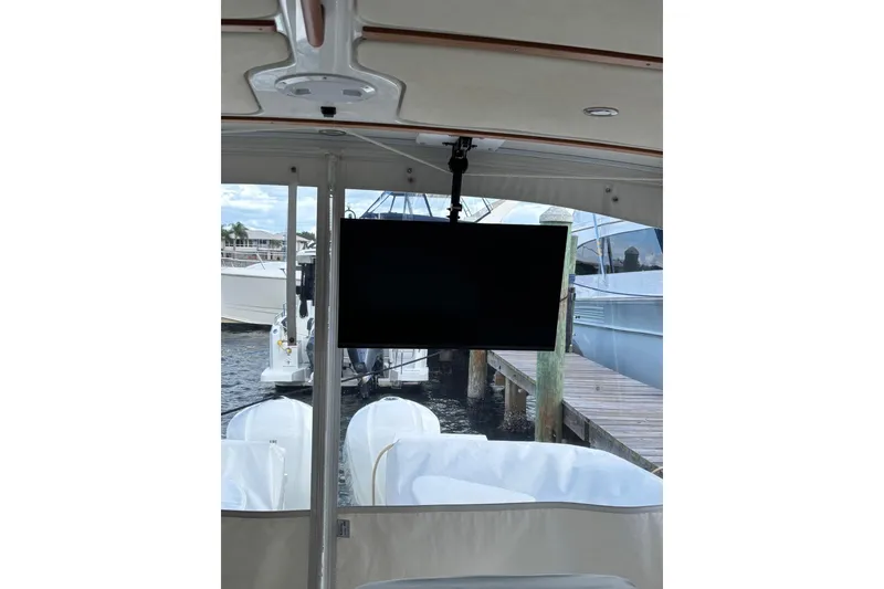 Slide: The Image of 2019 Back Cove 34O boat interior with mounted TV and marina view. - 10