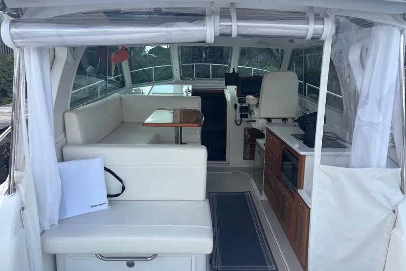 Slide: The Image of Interior view of 2019 Back Cove 34O boat with seating and kitchenette. - 12