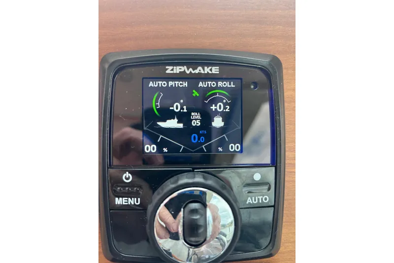 Slide: The Image of Zipwake control panel on a 2019 Back Cove 34O, displaying auto pitch and roll settings. - 16