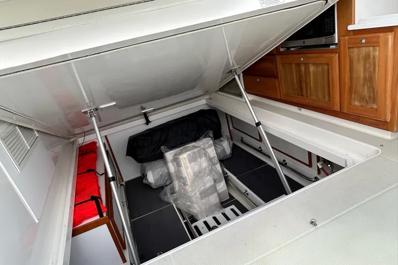 Slide: The Image of 2019 Back Cove 34O boat storage area with life jackets and equipment. - 23