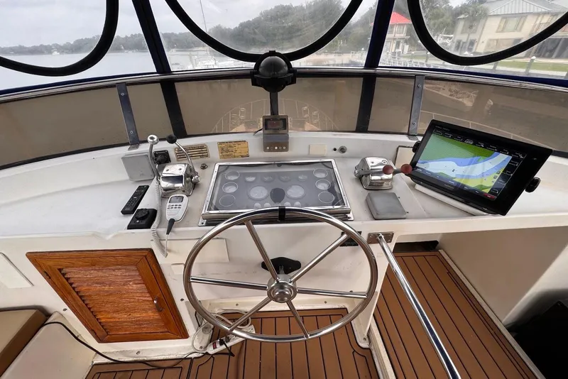 Slide: The Image of Helm of 1988 Jefferson 52 Monticello yacht with navigation equipment and wooden accents. - 14