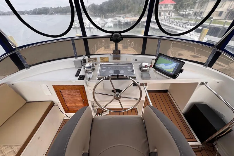 Slide: The Image of Helm of 1988 Jefferson 52 Monticello yacht with navigation equipment and steering wheel. - 15
