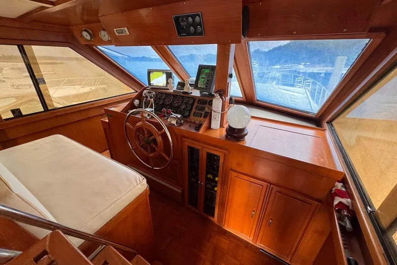 Slide: The Image of 1988 Jefferson 52 Monticello yacht helm with wooden dashboard and navigation equipment. - 18