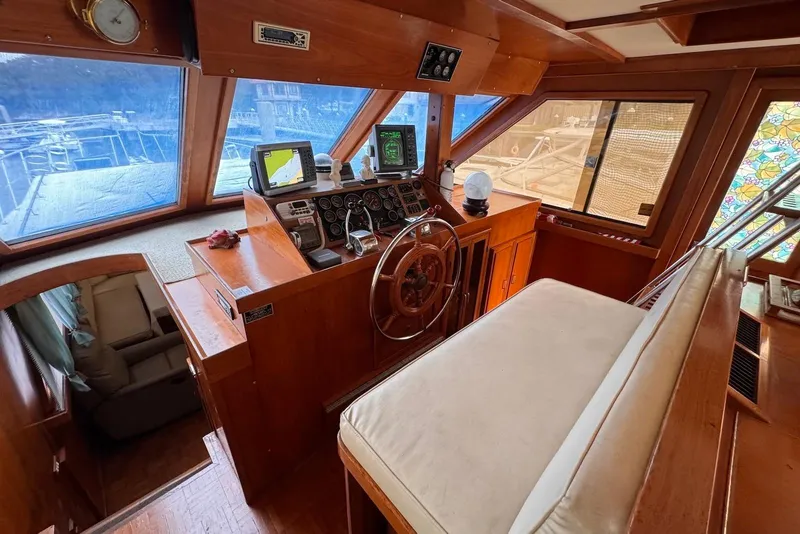 Slide: The Image of 1988 Jefferson 52 Monticello yacht helm with wooden interior and navigation equipment. - 19