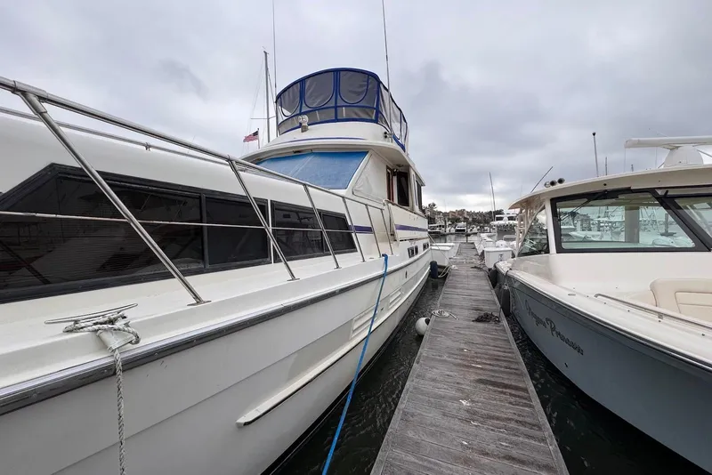 Slide: The Image of 1988 Jefferson 52 Monticello yacht docked at marina, overcast sky. - 2