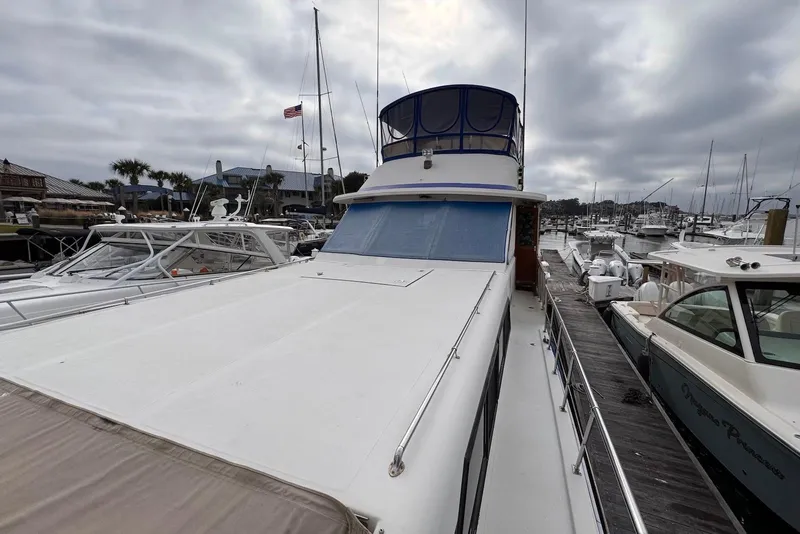 Slide: The Image of 1988 Jefferson 52 Monticello yacht docked at marina under cloudy sky. - 20