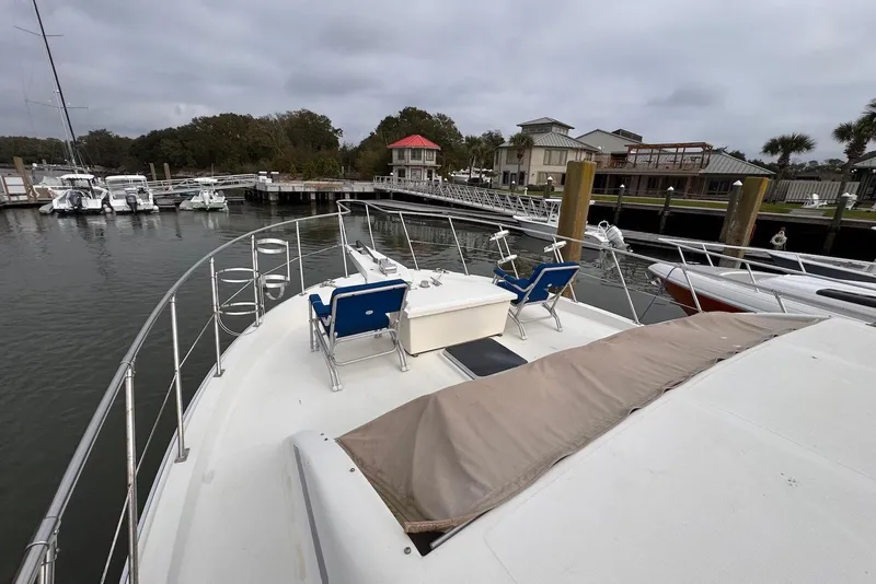 Slide: The Image of 1988 Jefferson 52 Monticello yacht docked at marina with scenic waterfront view. - 23